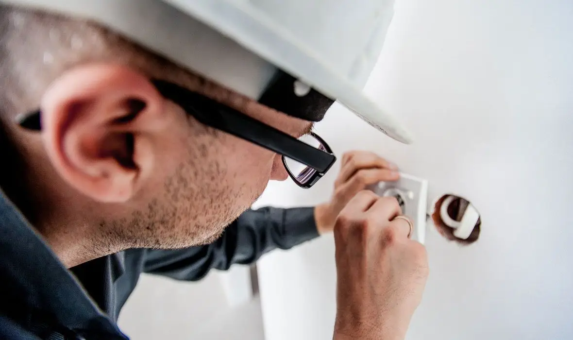 Electrician Repairing Wall Socket